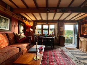 a living room with a couch and a table at The Writers Cottage - Intriguing & Romantic in Holmfirth