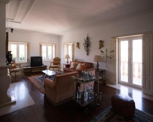a living room with a couch and a table at Casa Da Palmeira in Leiria