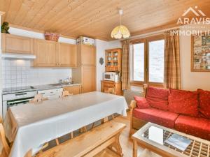 a kitchen and living room with a red couch at Appartement Le Grand-Bornand, 3 pièces, 5 personnes - FR-1-391-132 in Le Grand-Bornand
