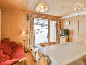 a room with a table and a couch and a window at Appartement Le Grand-Bornand, 3 pièces, 5 personnes - FR-1-391-132 in Le Grand-Bornand