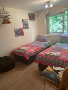 a bedroom with two beds and a window at 7 Wellington place in Chester