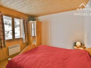 a bedroom with a red bed and a window at Appartement Le Grand-Bornand, 3 pièces, 5 personnes - FR-1-391-132 in Le Grand-Bornand