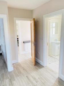 a room with a bathroom with a sink and a mirror at Portmagee Village Apartments in Portmagee