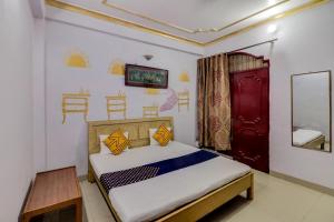 a bedroom with a bed and a red door at J C Guest House in Hasanganj