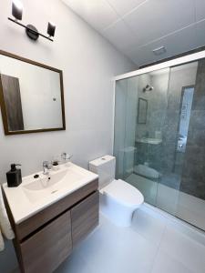 a bathroom with a toilet and a sink and a shower at Andean Homes in La Paz