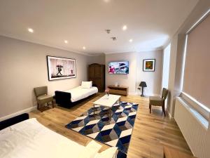 a living room with a bed and a table at The Beverley Apartments London - Victoria in London