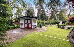 a small white and red camper in a yard at Awesome Home In Beekbergen With Wifi in Beekbergen +14 photos