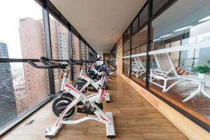 a row of bikes parked in a room with windows at The Equilibrium Collection in Centro Internacional in Bogotá