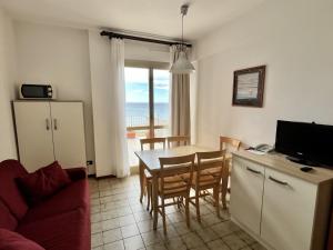 a kitchen and dining room with a table and chairs at Residence Stella Maris in Pietra Ligure