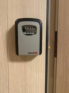 a black and white object on a wooden door at Argisht Luxury Apartment Golden Sands in Golden Sands