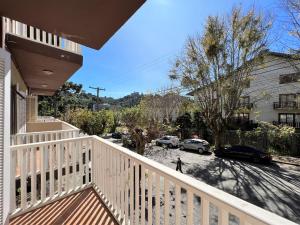a balcony of a house with cars parked in a parking lot at Hotel Solar da Montanha in Campos do Jordão