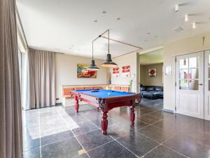 a living room with a pool table in it at Villa Meersen in Maldegem