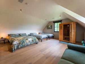 1 dormitorio en el ático con 2 camas y sofá en Landgoed Meersen, en Maldegem