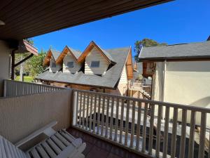 a balcony with a row of houses on the roof at Hotel Solar da Montanha in Campos do Jordão