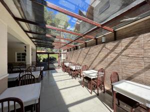 a restaurant with tables and chairs and a brick wall at Hotel Solar da Montanha in Campos do Jordão