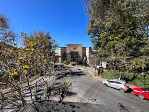 an empty street with cars parked in front of a building at Hotel Solar da Montanha in Campos do Jordão +21 photos