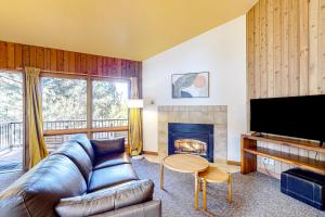 a living room with a couch and a fireplace at Adventures in Mount Bachelor #241 in Bend