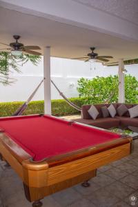 a pool table in a living room with a couch at Punta Leona, Al Pairo 52 in Punta Leona