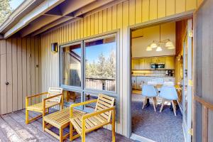 a patio with a table and chairs and a kitchen at Adventures in Mount Bachelor #241 in Bend