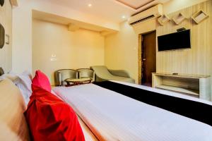 a hotel room with a bed and a tv at Collection O 30965 Baga Residency in Baga