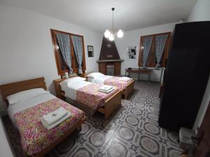 a hotel room with two beds and a tv at Appartamento Degli Dei (Affittacamere) in Madonna di Fornelli