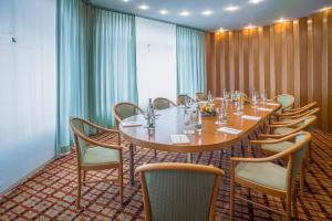 a conference room with a long table and chairs at Hotel Unione in Bellinzona