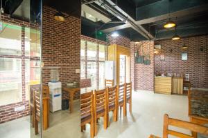 a dining room with a table and chairs and brick walls at OYO Flagship 69755 Hotel Parktel in Ghaziabad