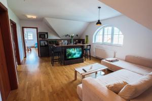 a living room with a couch and a tv at Apartment Sneznik in Stari Trg pri Ložu