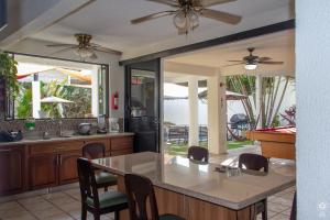 a kitchen with a table and chairs and a dining room at Punta Leona, Al Pairo 52 in Punta Leona
