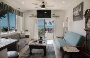 a living room with a couch and a table at Capitan Boutique Resort in Puerto Nuevo