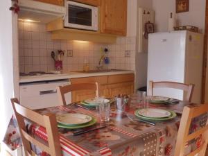 a kitchen with a table with plates and glasses on it at Appartement Crest-Voland, 3 pièces, 4 personnes - FR-1-595-75 in Crest-Voland