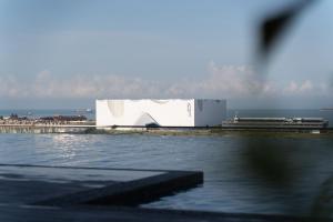 a large white building next to a body of water at Amber Cove Impression City Melaka By Dawn Stay Free Netflix in Malacca