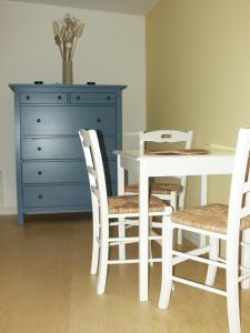 a dining room with a table and chairs and a dresser at Apartment Wittenberg in Lutherstadt Wittenberg