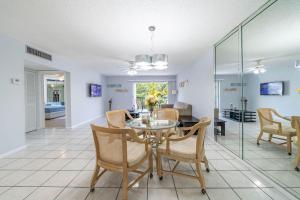 a dining room and living room with a table and chairs at Sunny Isles vacation condo. in Miami Beach