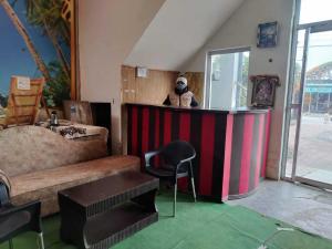 a living room with a panda bear sitting at a bar at Flagship Sitar Guest House in Rudrapur