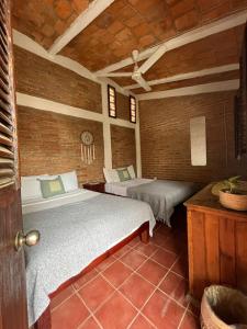 a bedroom with two beds in a room at Hosteria Chata Adults Only in Lo de Marcos