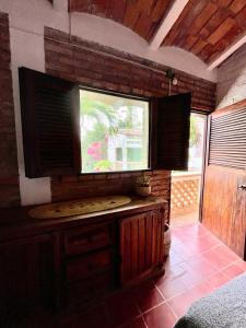a kitchen with a large window in a room at Hosteria Chata Adults Only in Lo de Marcos