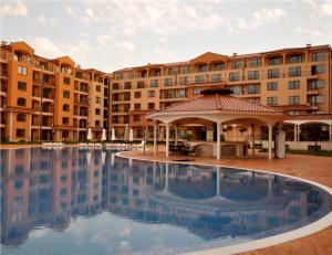 a large swimming pool in front of a building at Menada Diamant Apartments in Sunny Beach