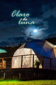 a large dome tent in a field at night at Glamping Claro de Luna in Guatavita