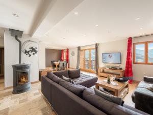 Una sala de estar con un sofá y una chimenea. en Appartement spacieux 6 pers, terrasse sauna proche pistes - FR-1-640-2, en Val Thorens