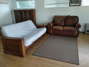 a living room with a bed and a couch at Waterfront Cabin - Homer Seaplane Base in Homer