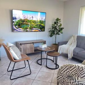 a living room with a couch and a table at AirportHouse in Dania Beach