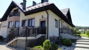 a house with a black roof at Pensjonat Emilia in Wysowa-Zdrój