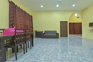 a living room with a couch and a table and a chair at Casaria Homestay Besut in Jertih