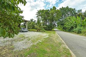 a car parked on the side of a road at Casaria Homestay Besut in Jertih +4 photos