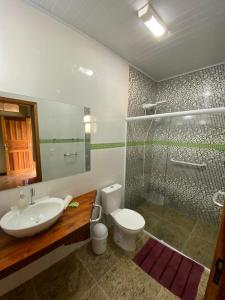 a bathroom with a sink and a toilet and a shower at RECANTO NA MATA in Morretes