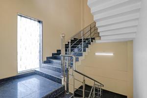 a staircase in a building with a window at Townhouse Hotel Hridaya Inn in Lucknow