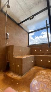 a large room with a large window with a shower at Edificio Helena in Medellín