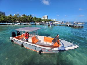 two people on a boat in the water at Apartamentos Isla Tropical in San Andrés