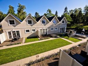 a large white house with a large yard at Comfortable, two-story holiday houses for 6 people, Pobierowo in Pobierowo